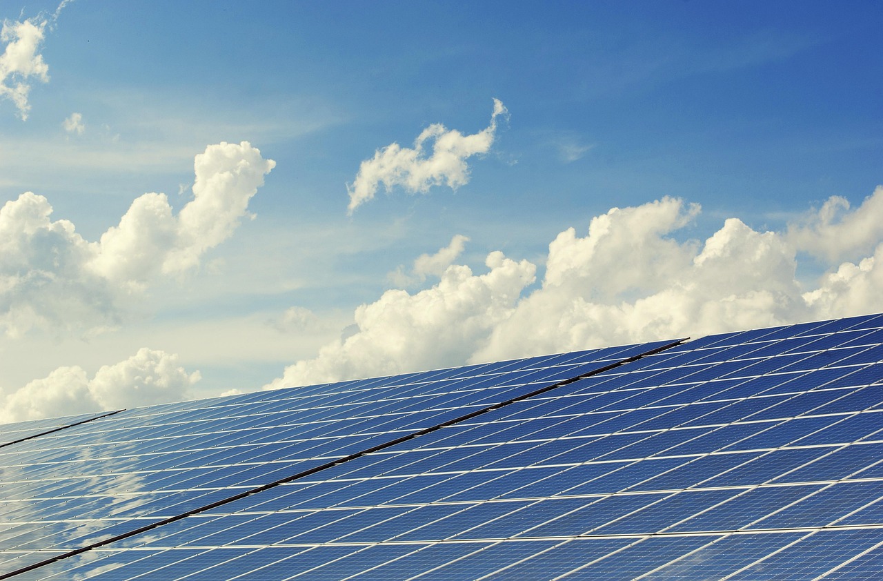 Aerial view of rows of solar panels at a large solar farm for inspection