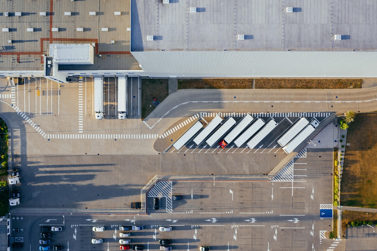 Aerial night view of a secured industrial facility perimeter lit at night